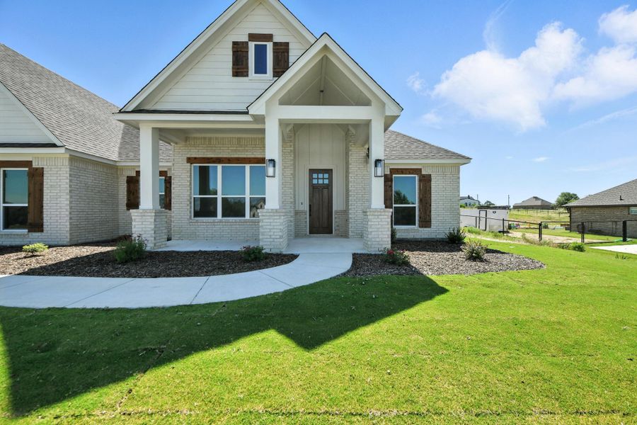 Front exterior of a home in the Whispering Winds community, located in Springtown, TX (Image 8).