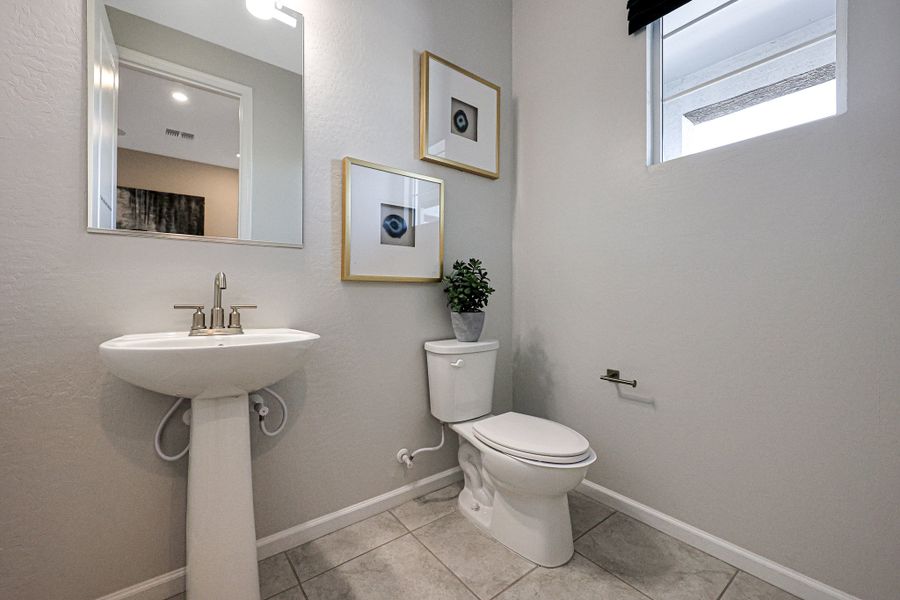 A bathroom with a sink toilet and mirror. A bathroom with a sink toilet and mirror.