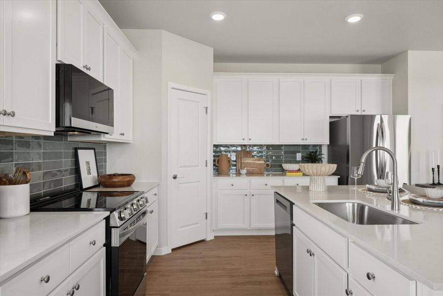 A kitchen with white cabinets. A kitchen with white cabinets.
