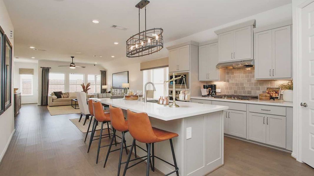 Elegant quartz countertops and bespoke cabinetry elevate this Cypress Green culinary space. Elegant quartz countertops and bespoke cabinetry elevate this Cypress Green culinary space.