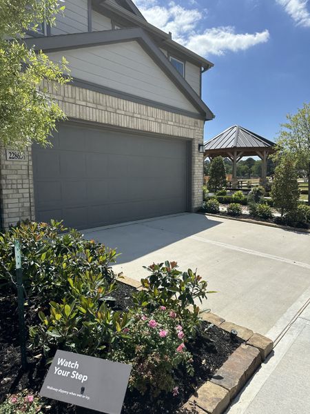 Charming home with a spacious driveway and lush landscaping in Bauer Meadow by KB Home (Hockley, TX).