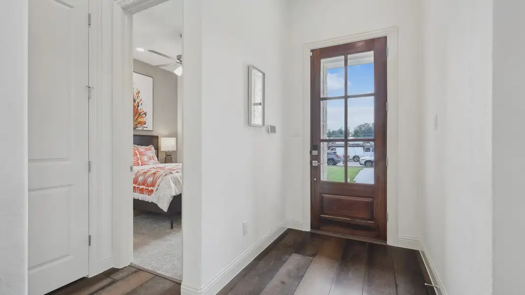 Exquisite wood flooring complements the glass-panel door in this Heritage Park residence.