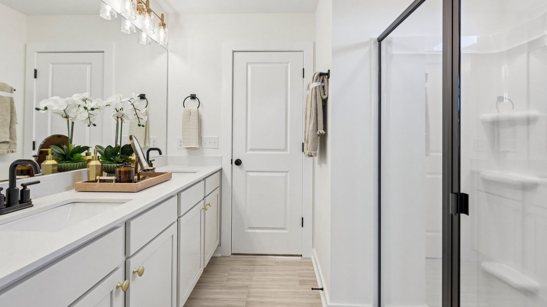 Primary bathroom with dual vanity and glass enclosed Primary bathroom with dual vanity and glass enclosed