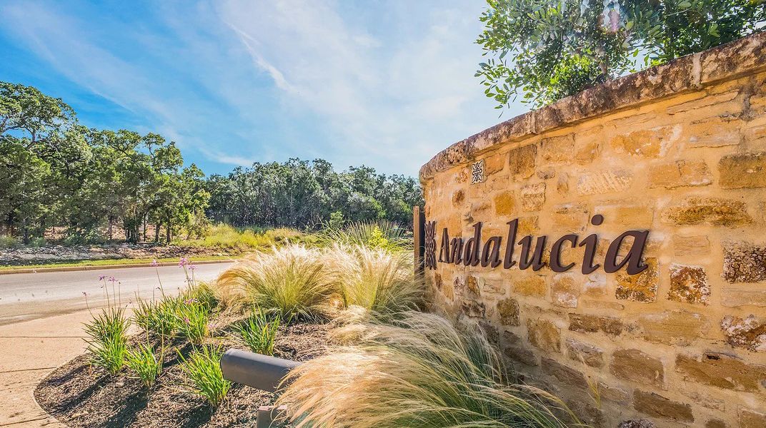 Entrance to the Andalucia At The Dominion community in Shavano Park, TX, featuring signage and landscaping (Image 1).