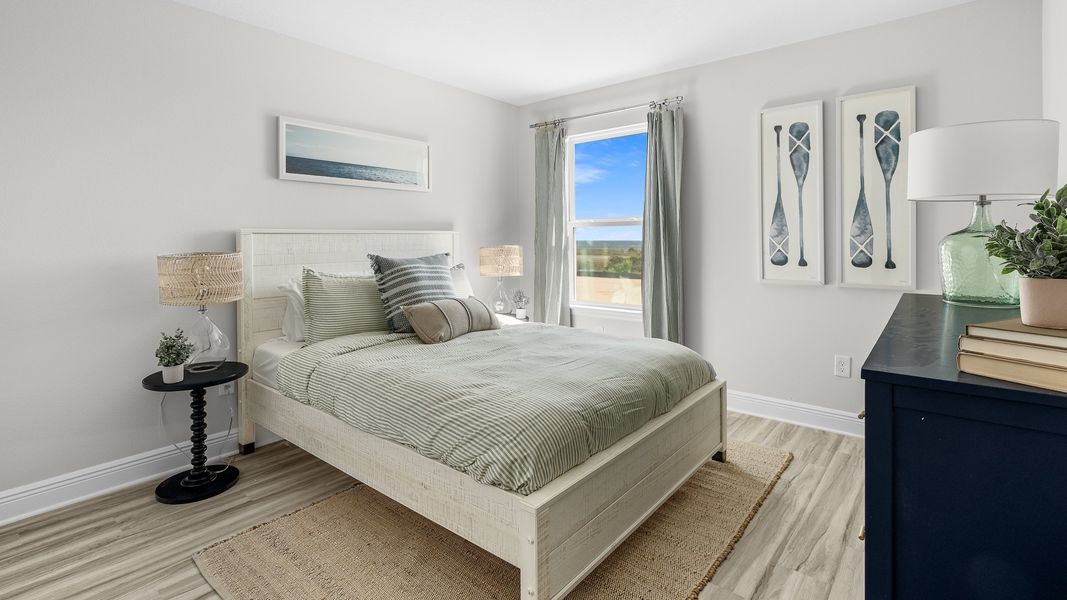 Furnished interior in a model home at WindMark Townhomes in Port Saint Joe (Image 26).