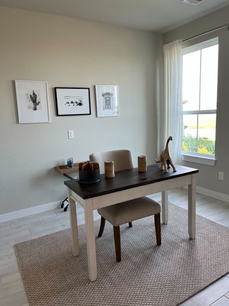 A minimalist home office with a sleek desk, neutral decor, and large window providing natural light. A minimalist home office with a sleek desk, neutral decor, and large window providing natural light.