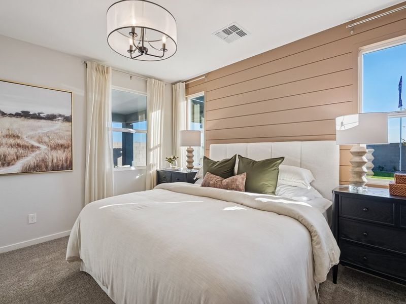 A bedroom with a bed and lamps. A bedroom with a bed and lamps.