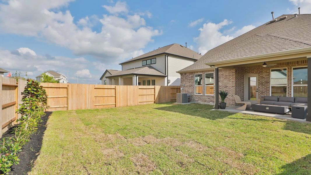 Elegant brick patio with refined wooden fencing and plush seating, River Ranch community. Elegant brick patio with refined wooden fencing and plush seating, River Ranch community.