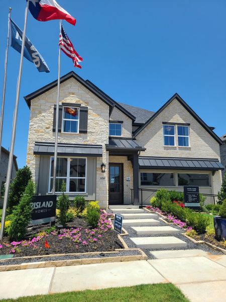 A beautiful stone-facade home with manicured landscaping in Creekview Meadows by Risland Homes (Celina, TX).