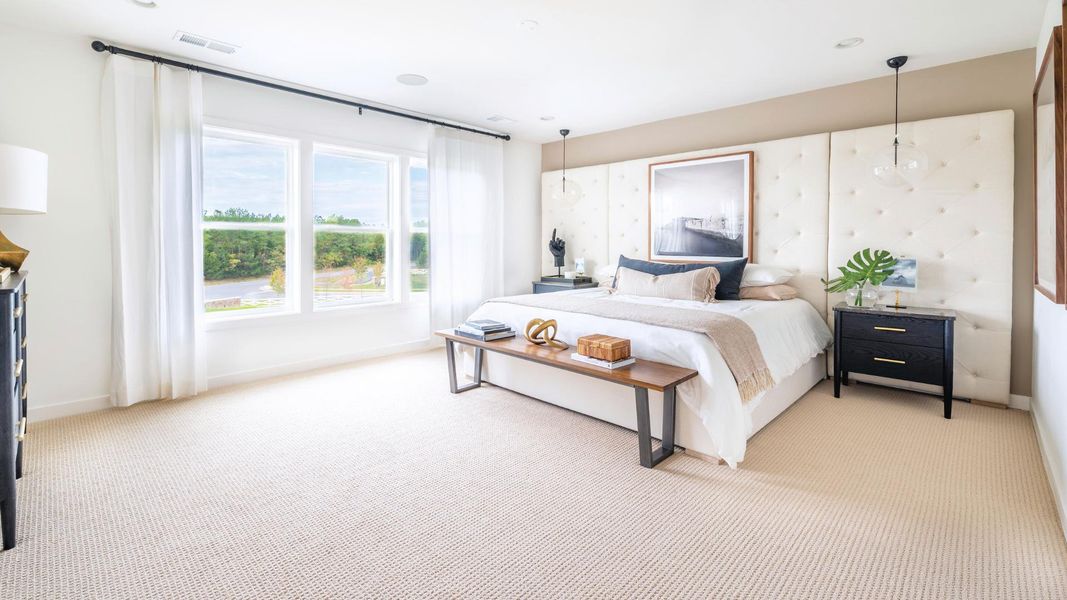 Spacious primary bedroom with space for seating area Spacious primary bedroom with space for seating area