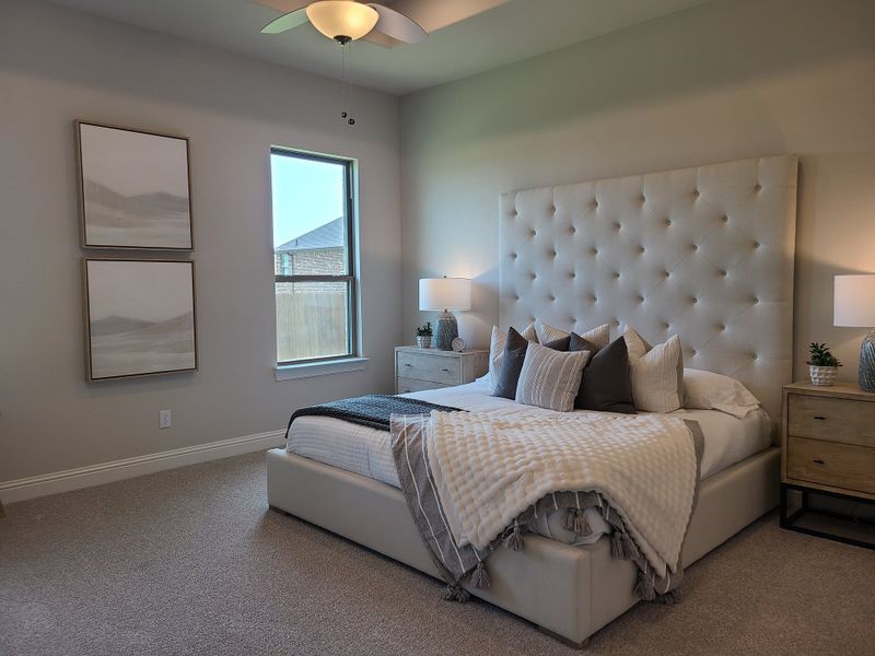 A cozy bedroom with a plush tufted headboard, soft lighting, and neutral decor accents creating a serene atmosphere.