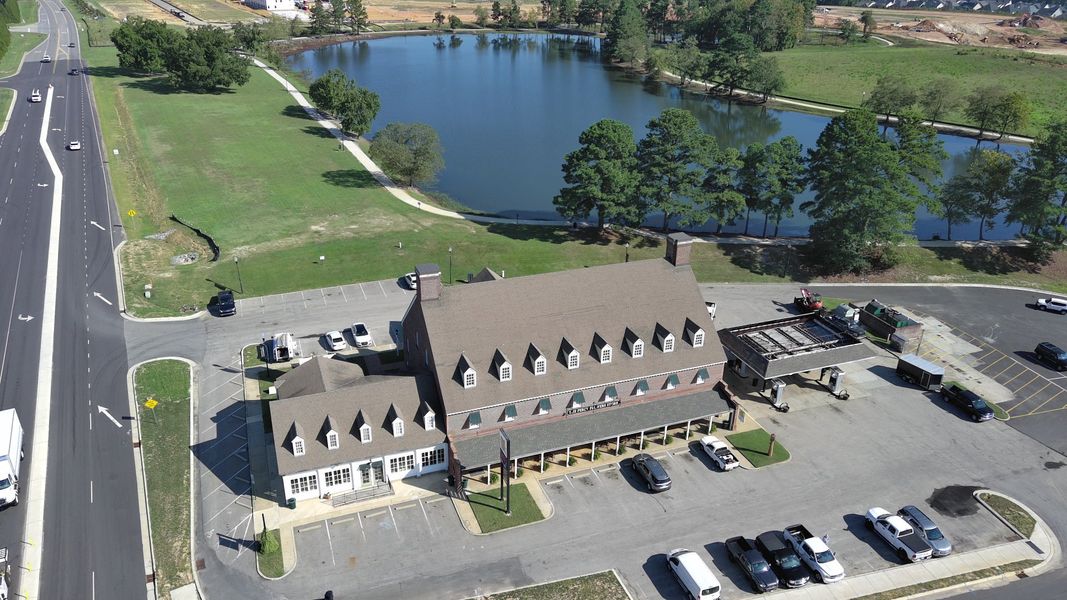 Aerial view of the South Lake Townes at Flowers Plantation community in Clayton, NC, showing layout and nearby surroundings (Image 14).