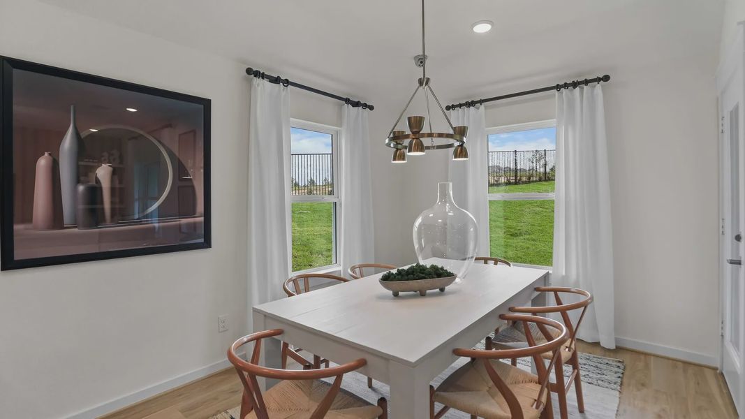 Elegant dining room with natural light, sophisticated chandelier, and refined wood floor in Mostyn Springs. Elegant dining room with natural light, sophisticated chandelier, and refined wood floor in Mostyn Springs.