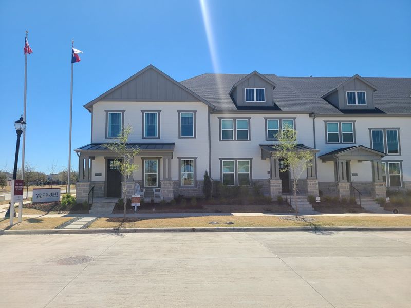 Elegant townhome with a modern facade in Village on Main Street by CB JENI Homes (Frisco, TX).