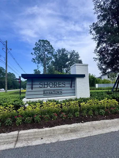Elegant entrance sign surrounded by lush landscaping at RiverTown - Meadows by Mattamy Homes, St. Johns, FL.
