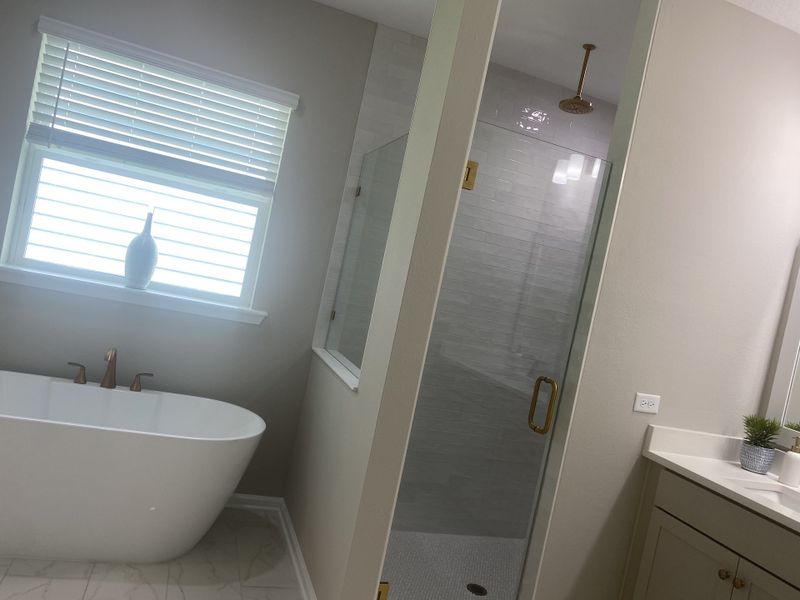 A luxurious bathroom featuring a freestanding tub, glass shower, and sleek vanity with modern fixtures. A luxurious bathroom featuring a freestanding tub, glass shower, and sleek vanity with modern fixtures.