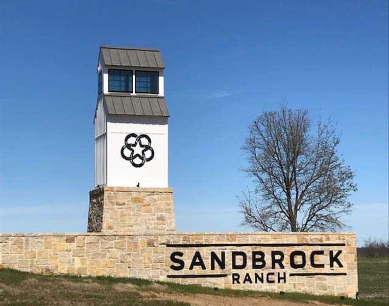 Entrance to the Sandbrock Ranch community in Aubrey, TX, featuring signage and landscaping (Image 2).