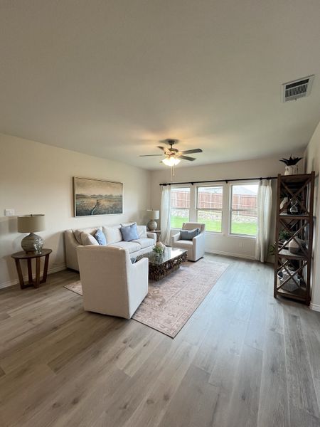 A cozy living room featuring light wood flooring, a neutral color palette, and elegant furnishings with abundant natural light. A cozy living room featuring light wood flooring, a neutral color palette, and elegant furnishings with abundant natural light.