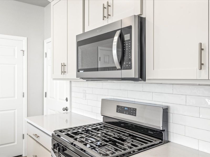 Kitchen in the Woodland floorplan at a Meritage Homes community in Broomfield, CO.