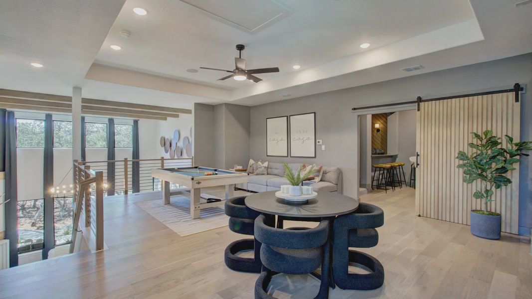 Elegant open-concept with sleek wood accents and expansive windows in Verandas at the Rim, San Antonio.