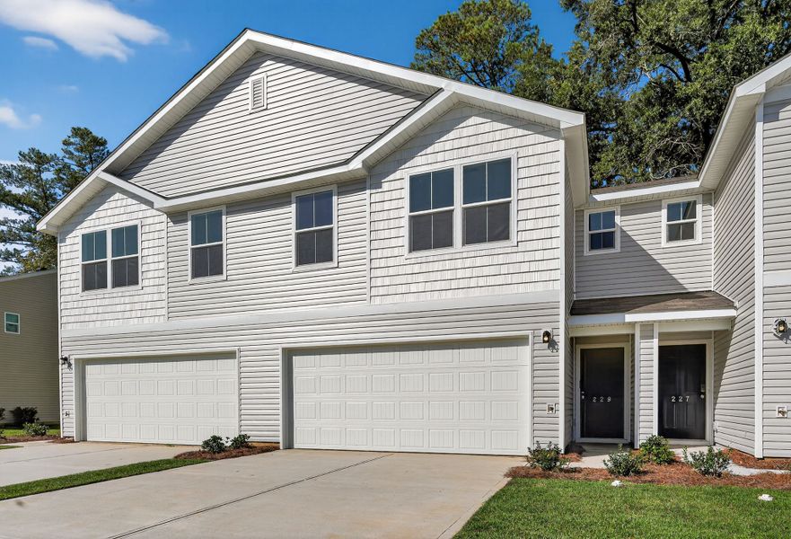 A white house with garages with Ronald Reagan Boyhood Home in the background.
