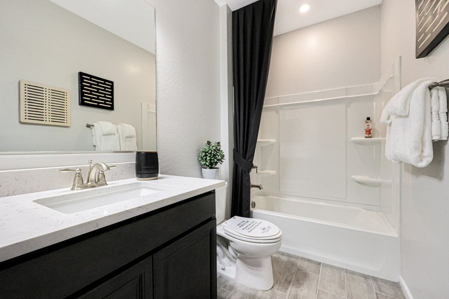 A bathroom with a tub sink and toilet. A bathroom with a tub sink and toilet.