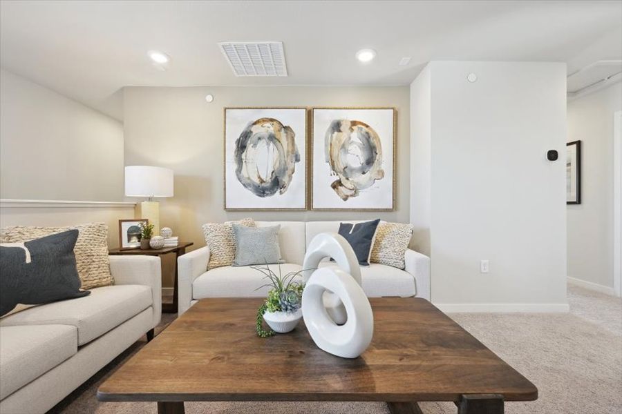 A living room with a table and couches.