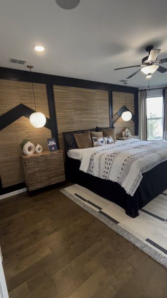 A chic bedroom with textured accent wall, modern pendant lights, and stylish bedding.