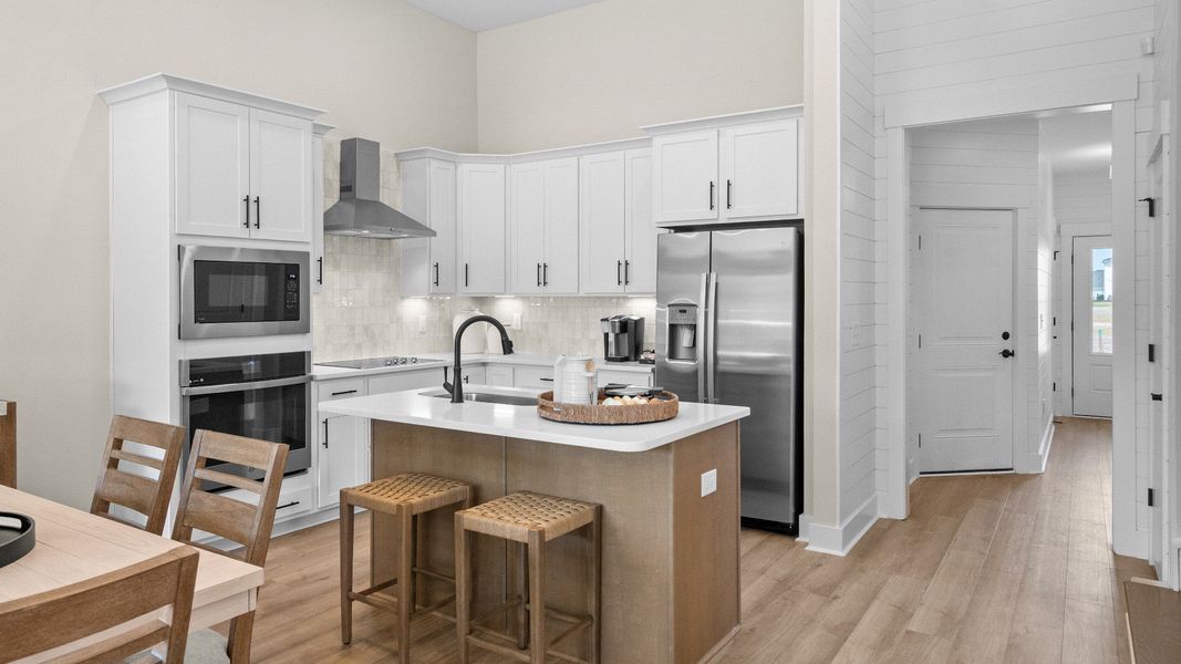 Open kitchen in the Summit home plan with modern cabinetry and natural light.