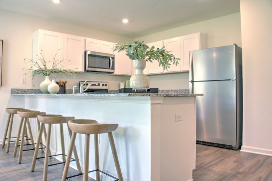 A kitchen with a table and stools.