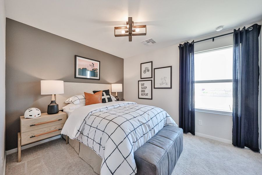 A bedroom with a bed and a desk.