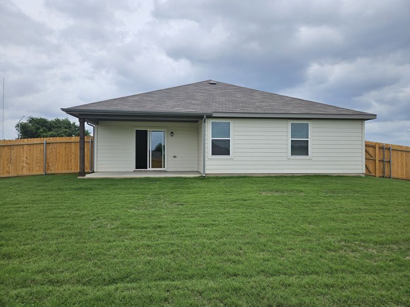A charming white home with a spacious fenced yard in Middlefield Village by Century Communities (Dallas, TX).