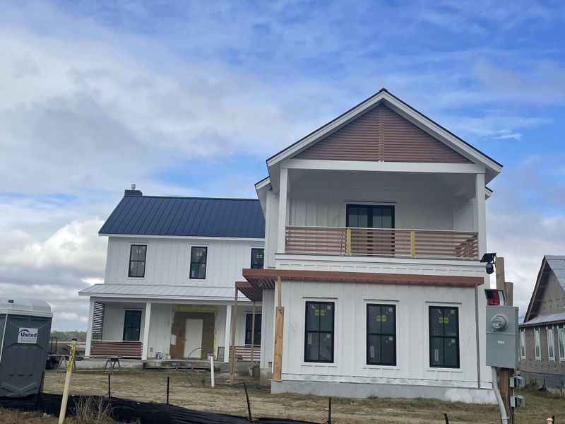 A modern white home with sleek windows and a dual-tiered design in The Settlement at Ashley Hall by Homes by Dickerson (Charleston, SC). A modern white home with sleek windows and a dual-tiered design in The Settlement at Ashley Hall by Homes by Dickerson (Charleston, SC).