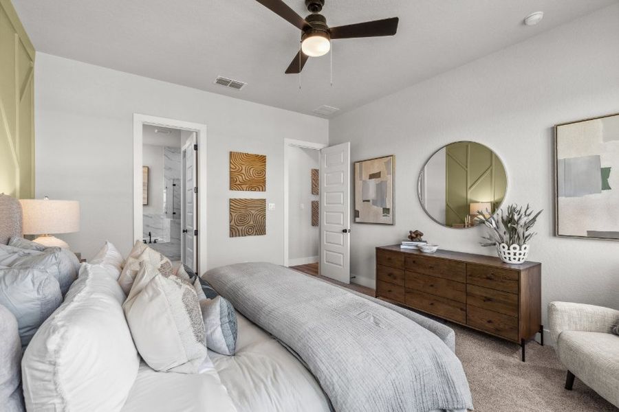 A bedroom with a bed and a fan.