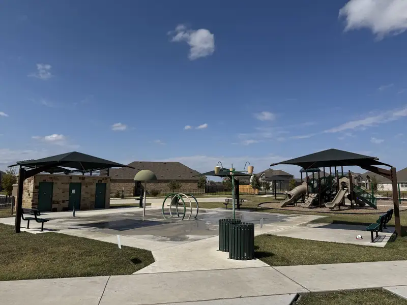 A delightful community park with playground and seating in Highlands North by Brightland Homes (Hutto, TX). A delightful community park with playground and seating in Highlands North by Brightland Homes (Hutto, TX).