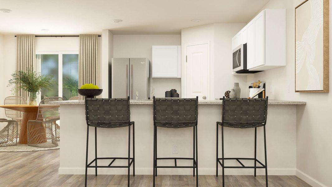 A kitchen with a table chairs and a refrigerator.
