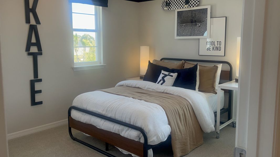 A cozy bedroom featuring a modern metal bed, warm earthy tones, and stylish wall art, creating a welcoming atmosphere. A cozy bedroom featuring a modern metal bed, warm earthy tones, and stylish wall art, creating a welcoming atmosphere.