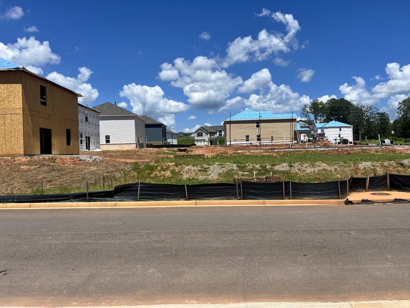 New homes under construction under a clear sky in Millers Pointe by Lennar (Conyers, GA).
