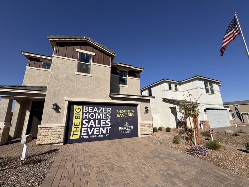 A modern home with a spacious driveway in Bethany Grove by Beazer Homes, set under clear skies in Glendale, AZ.