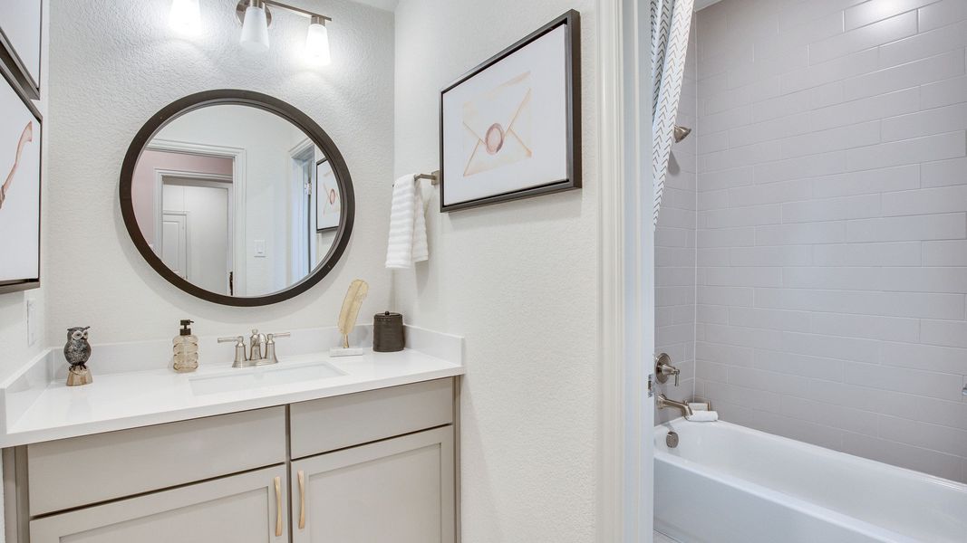 Elegant Opal Ranch bathroom with subway tile, round mirror, and sleek fixtures in a seamless design.