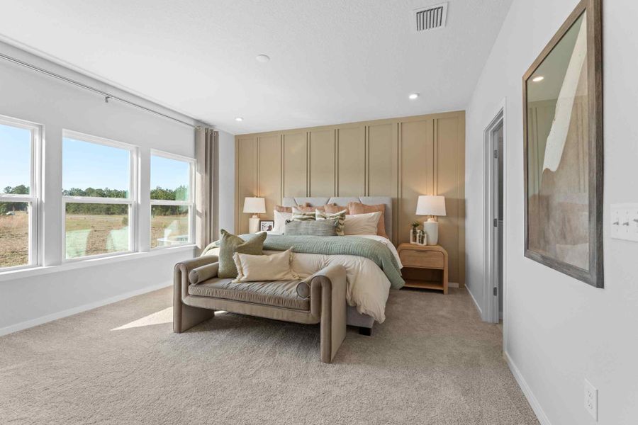 A bedroom with a bed and a mirror. A bedroom with a bed and a mirror.