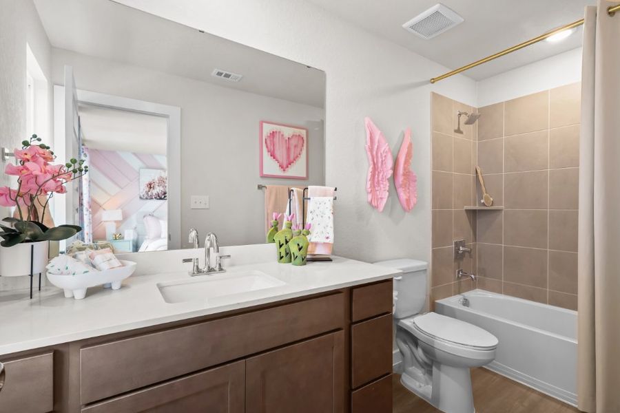A bathroom with a sink toilet and bathtub. A bathroom with a sink toilet and bathtub.