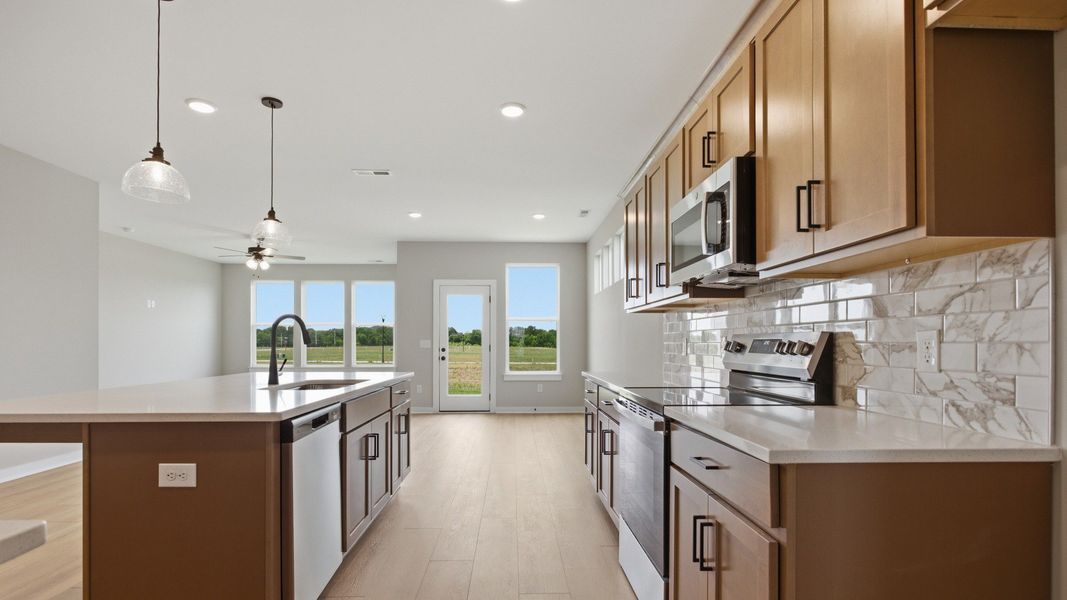 Lassiter plan kitchen with quartz countertops and tile backsplash Lassiter plan kitchen with quartz countertops and tile backsplash