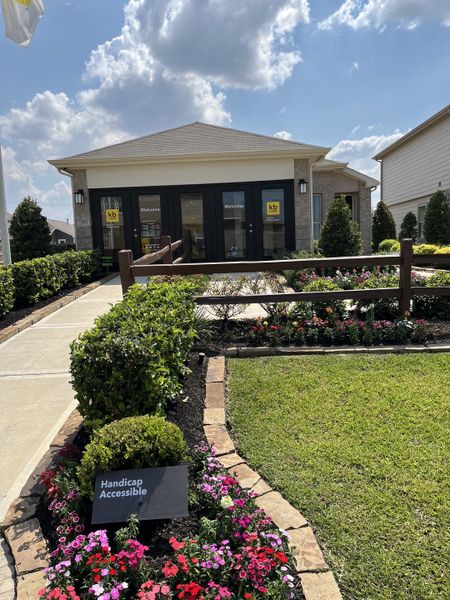 A welcoming single-story brick building with lush landscaping in Bauer Meadows by KB Home (Hockley, TX).