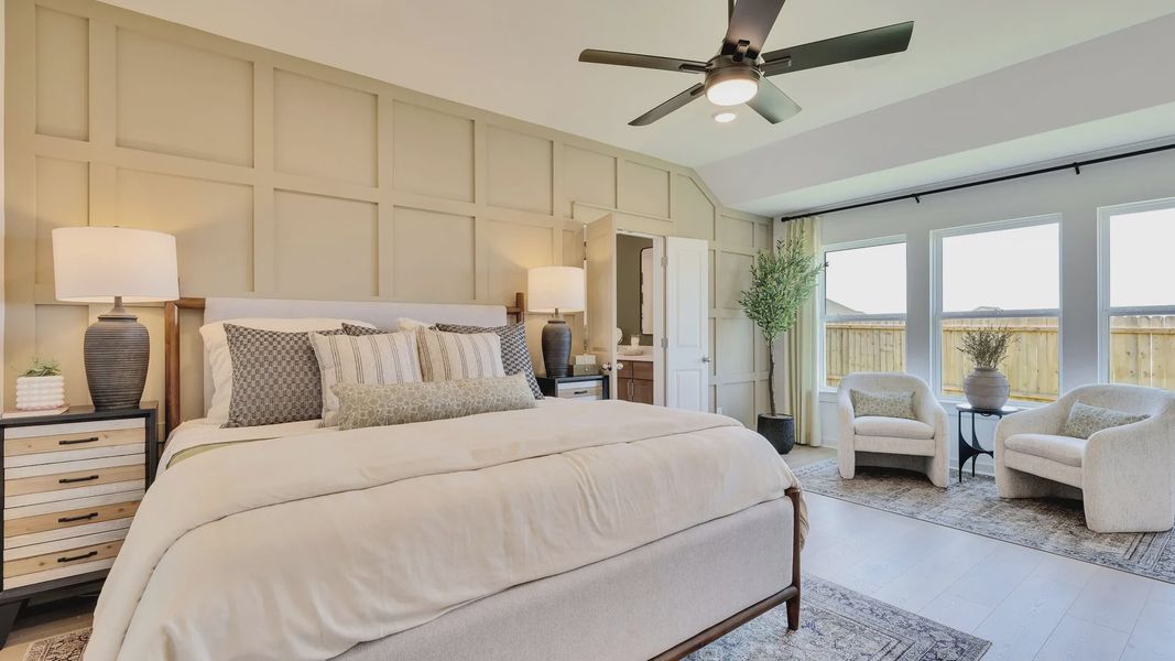 Luxurious bedroom in Hunters Glen, featuring elegant beige paneled walls and expansive windows for natural lighting. Luxurious bedroom in Hunters Glen, featuring elegant beige paneled walls and expansive windows for natural lighting.