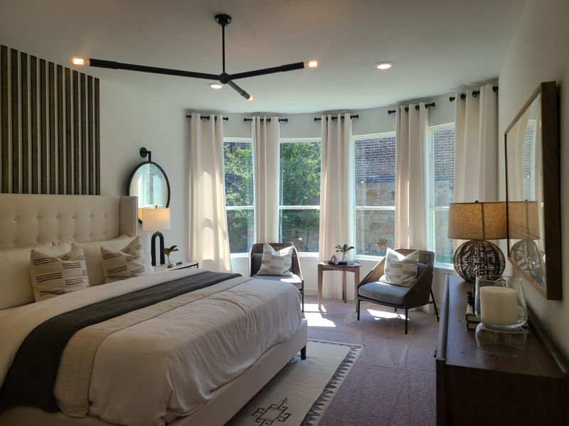 A cozy bedroom featuring a plush bed, modern lighting, and large windows with elegant curtains. A cozy bedroom featuring a plush bed, modern lighting, and large windows with elegant curtains.