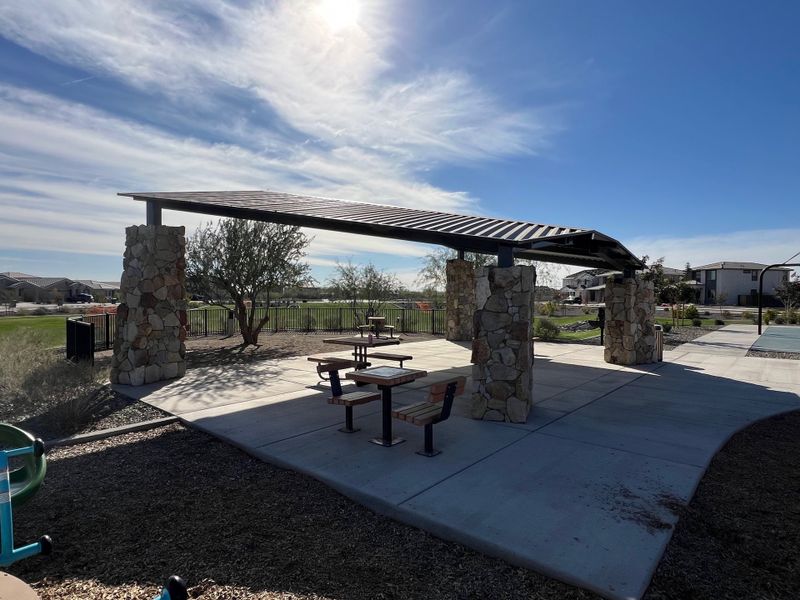 A charming outdoor pavilion with picnic tables in Tirreno at IronWing by Beazer Homes, Litchfield Park, AZ.