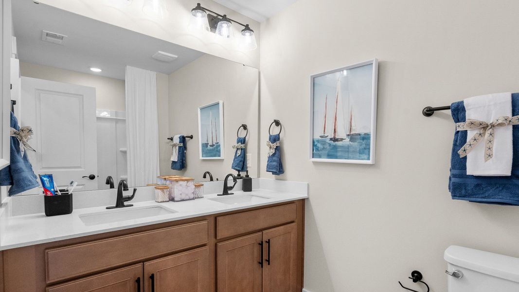 Second-floor secondary bathroom in the Summit home plan with modern fixtures and style.
