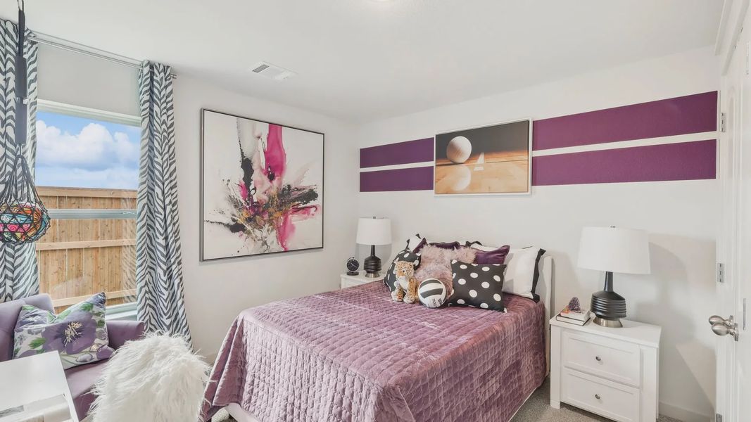 Plush plum textiles and striking abstract art define this exquisite Still Water Lake Estates bedroom.
