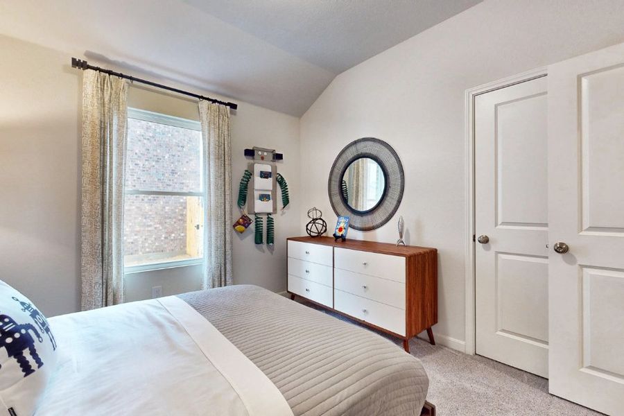 A bedroom with a mirror and a dresser. A bedroom with a mirror and a dresser.